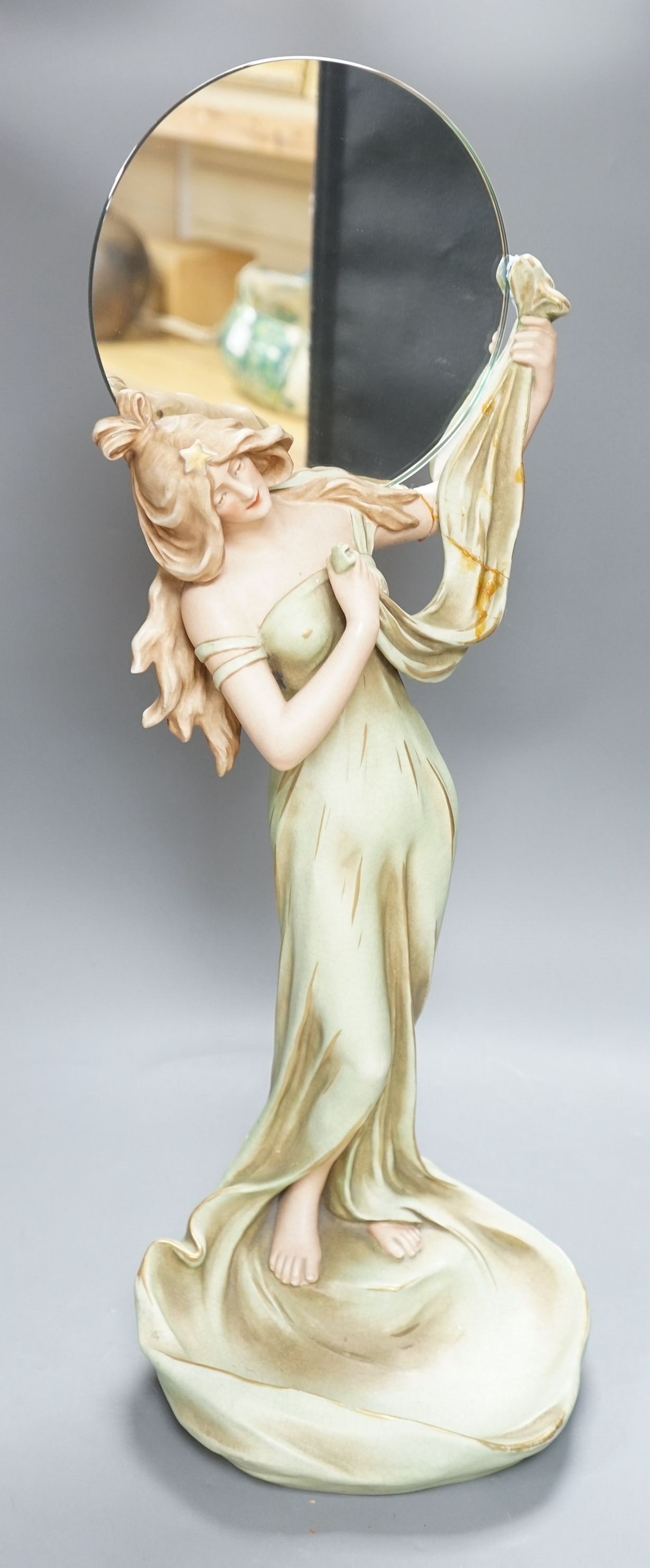 A continental Art Nouveau ceramic figure of a lady holding a mirror, 57cms high not including mirror